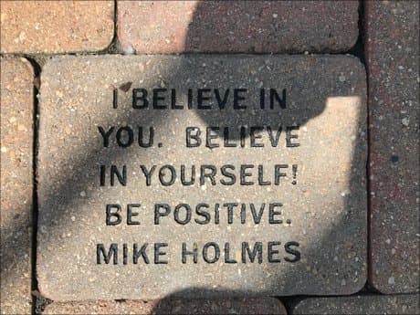 brick in a wall and a quote by Mike Holmes