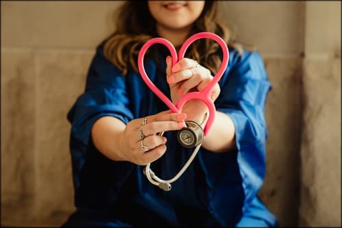 nurse and stethoscope shaped like a heart