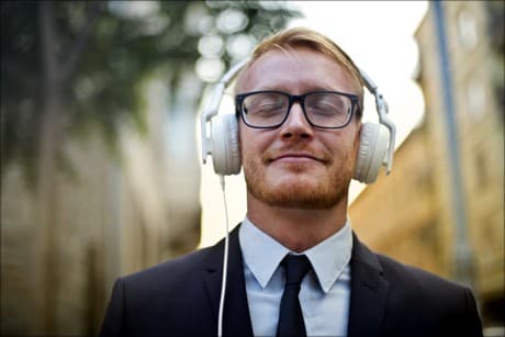 man with headphones on and smiling