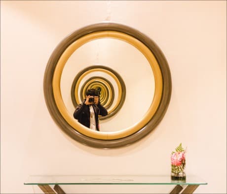 photographer takinga picture through a mirror