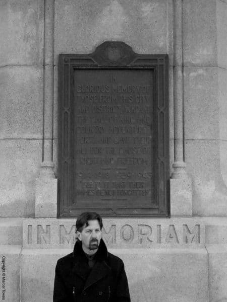 Miles Patrick Yohnke in front of a memorial in Canada