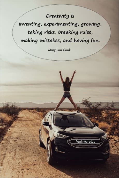 woman on top of a vehicle with her arms on the air