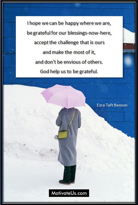 quote on a wall by Ezra Taft Benson and a woman with an umbrella looking at it