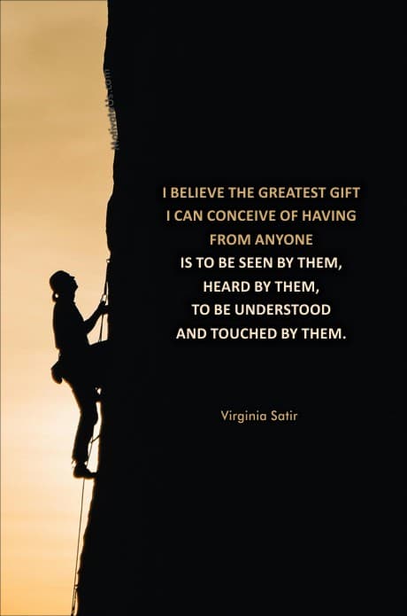 person climbing a wall of rock