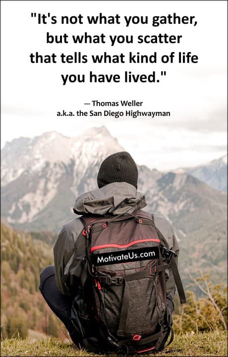 person with a backpack sitting and looking at the mountains