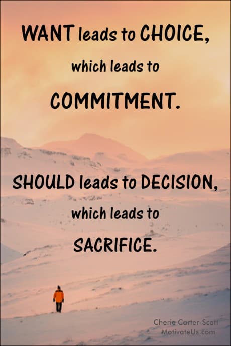 person in winter gear walking through snow towards the mountain