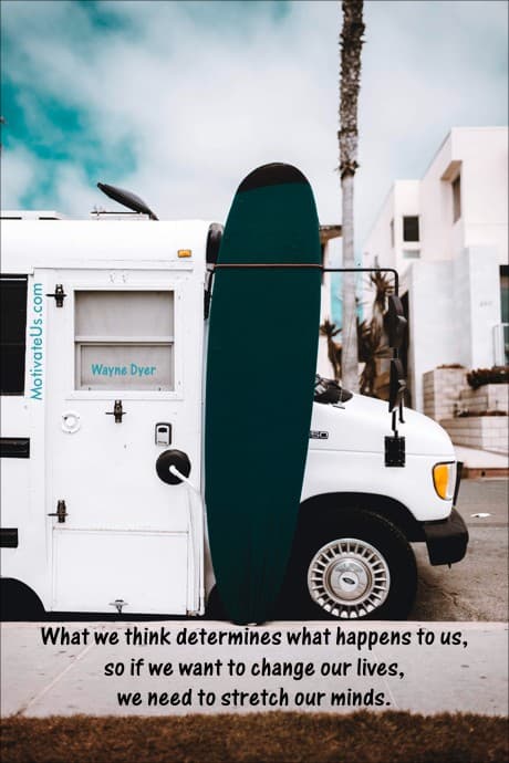 bus with a surfboard hanging off the side