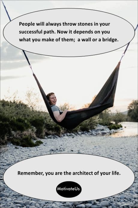 man smiling in a hammock above a stone covered path and a positive quote