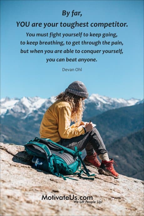 woman on mountain writing in a journal