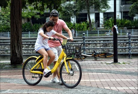 father and daughter - learning to ride a bike