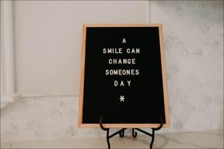 A smile can change someone's day sign