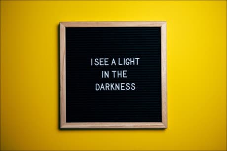 a sign that says - I see a light in the darkness